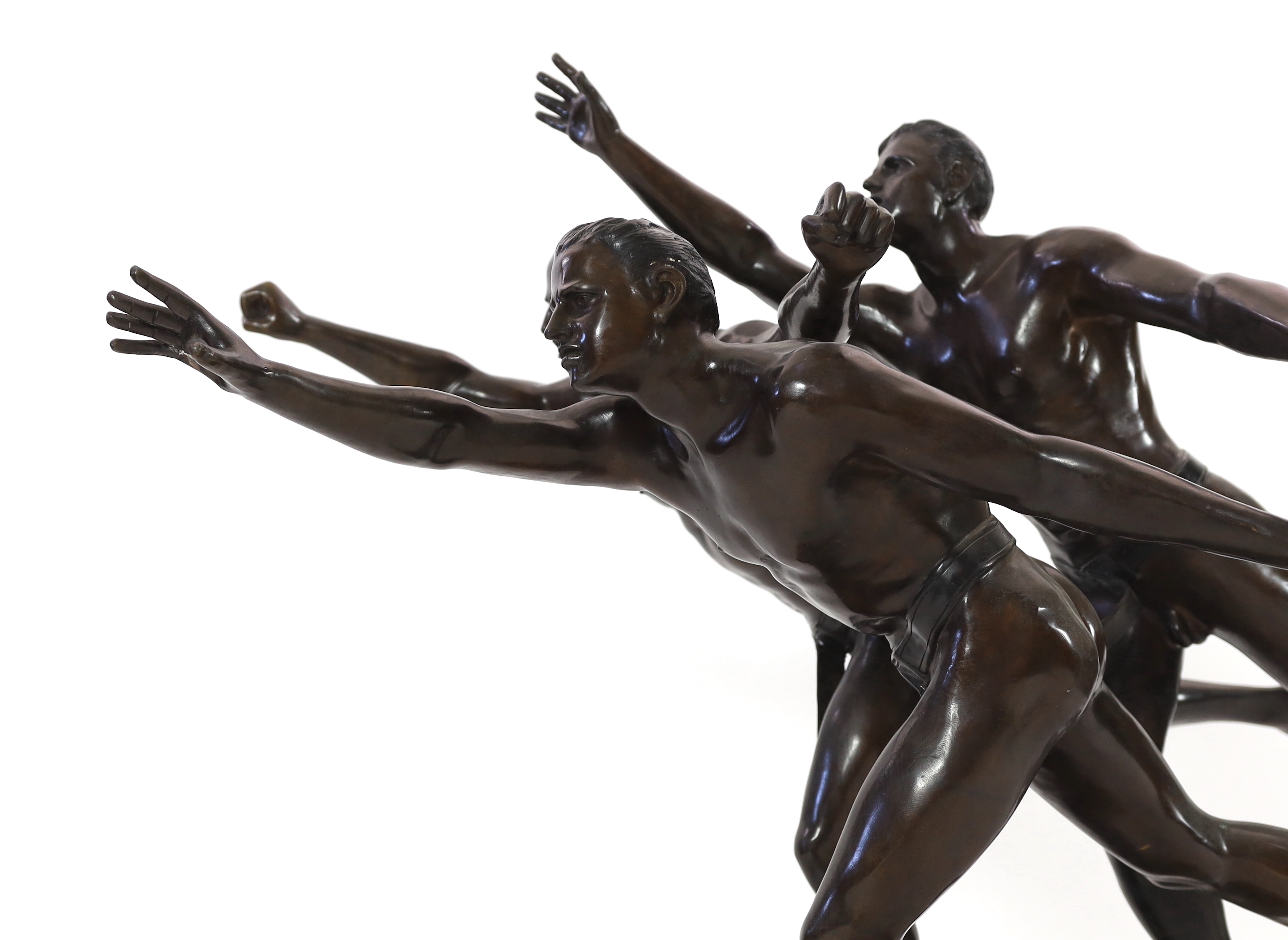 After Alfred Boucher (French, 1850-1934). A large bronze group of three runners at the finishing line, 'Au But', 128cm long, 78cm deep, 111cm high